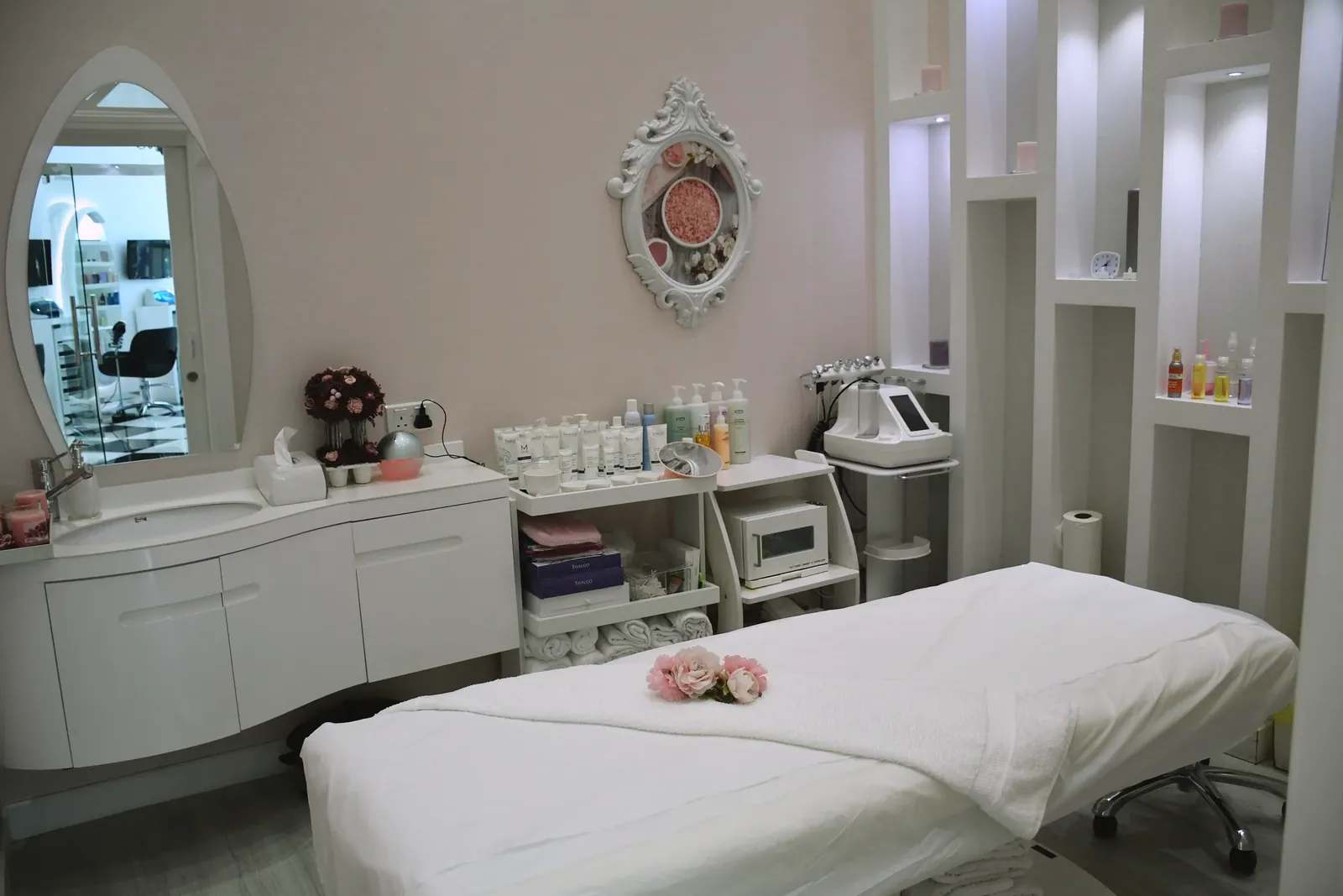 Bright, elegant treatment room with a made treatment bed
